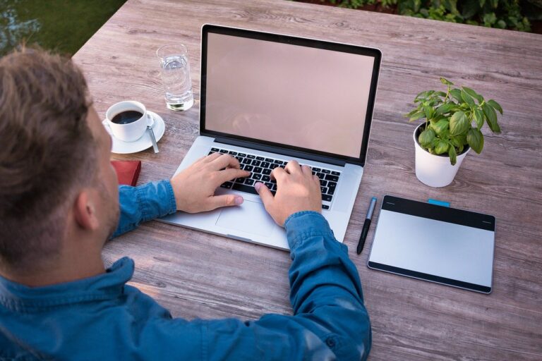 Man Typing Wooden Desk
