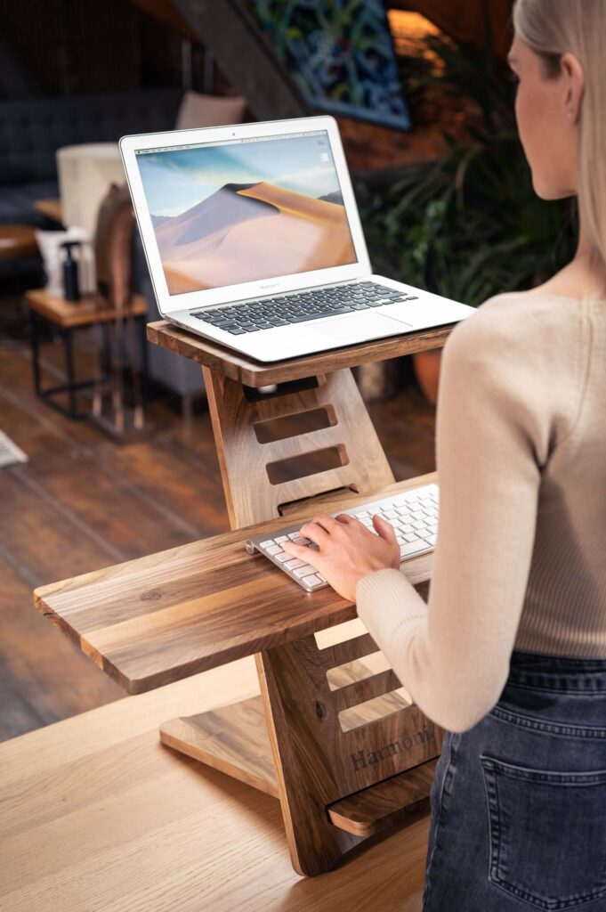 Lady at Height Adjustable Wooden Desk with Laptop