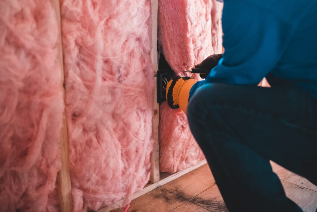 Man Installing Pink Insulation