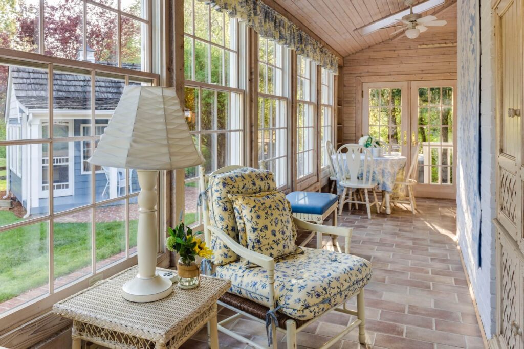 Sunroom with a breakfast table and sitting chair with table and lamp
