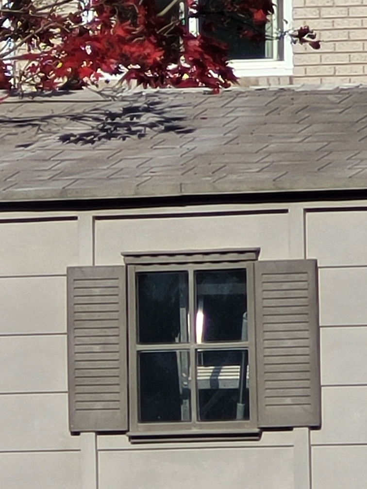 Close up view of the side window of a shed converted into an office