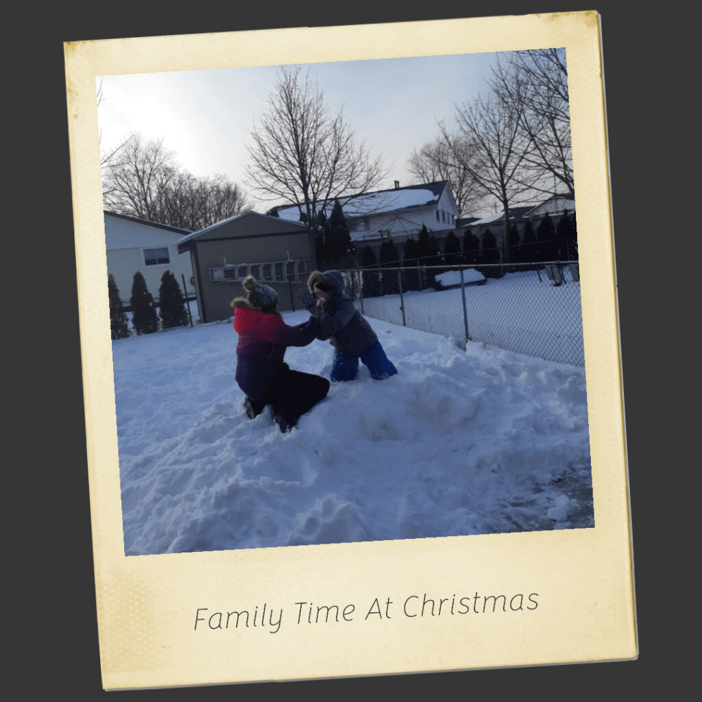 A framed classic photo of kids playing in the snow with the caprtion Family Time at Christmas representing Christmas Card Design as one of the more fun Christmas Business Ideas.