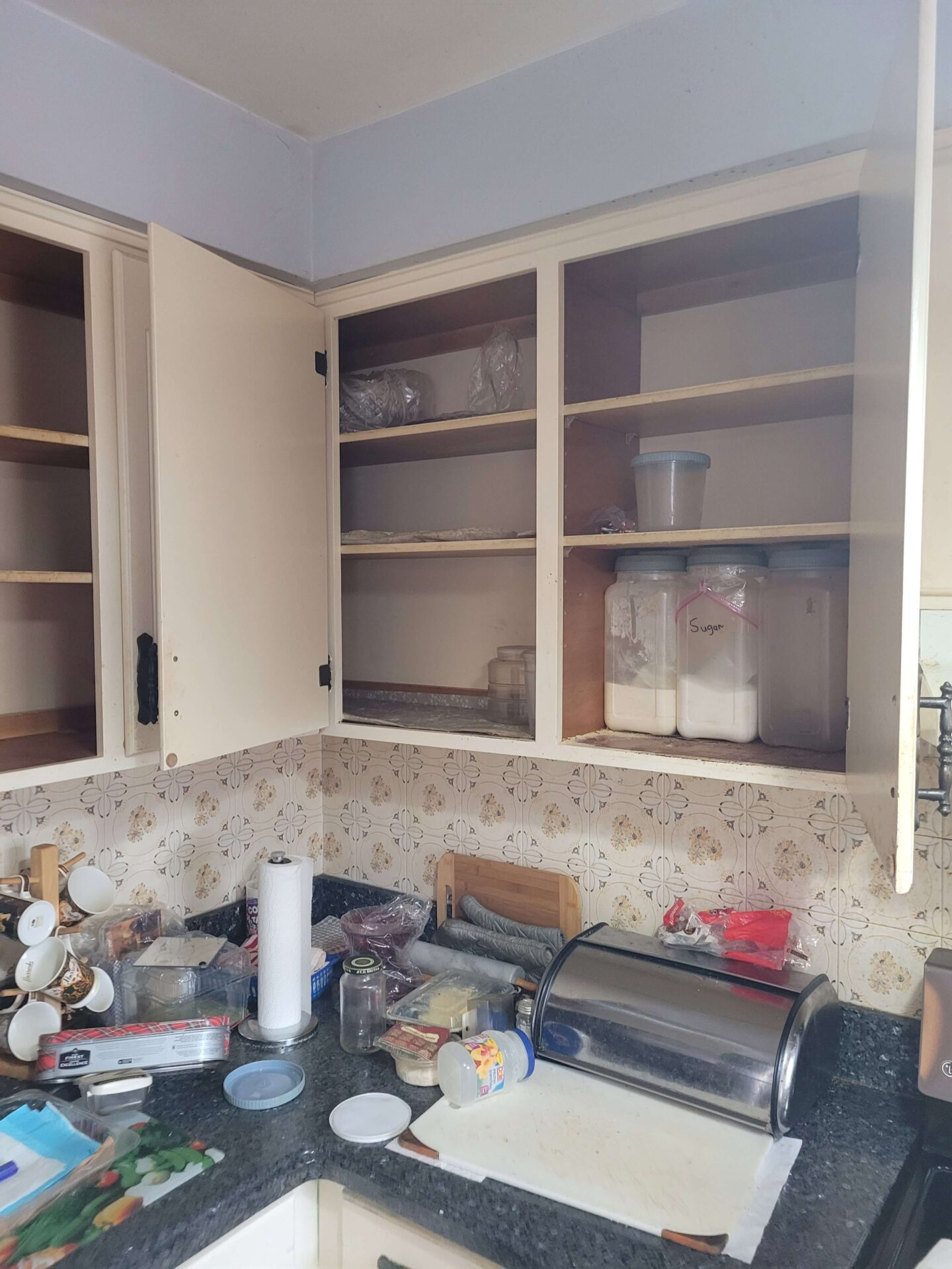 A picuture of cupboards being decluttered by a decluttering expert number 55 in our list of backyard business ideas.